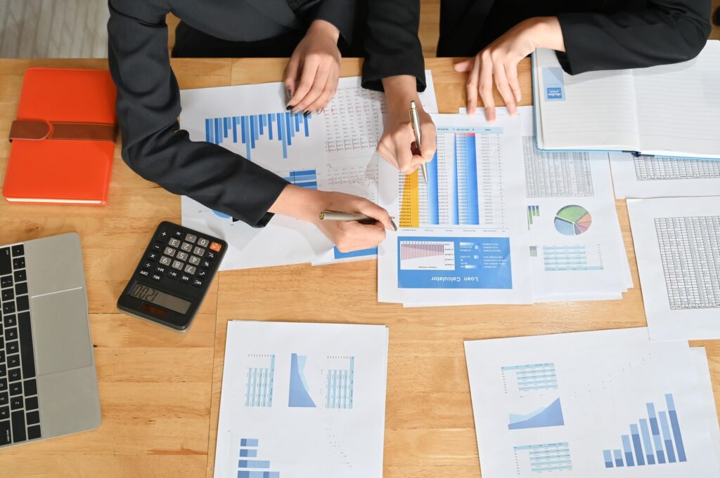 Meeting of financial, Two business working with finance paper and calculator with top view.